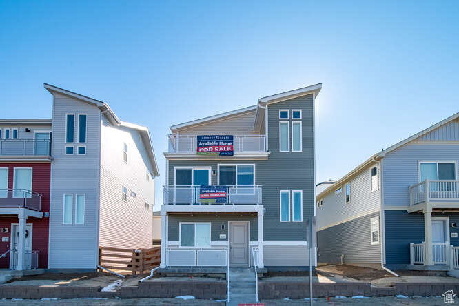 View of front of property with a balcony