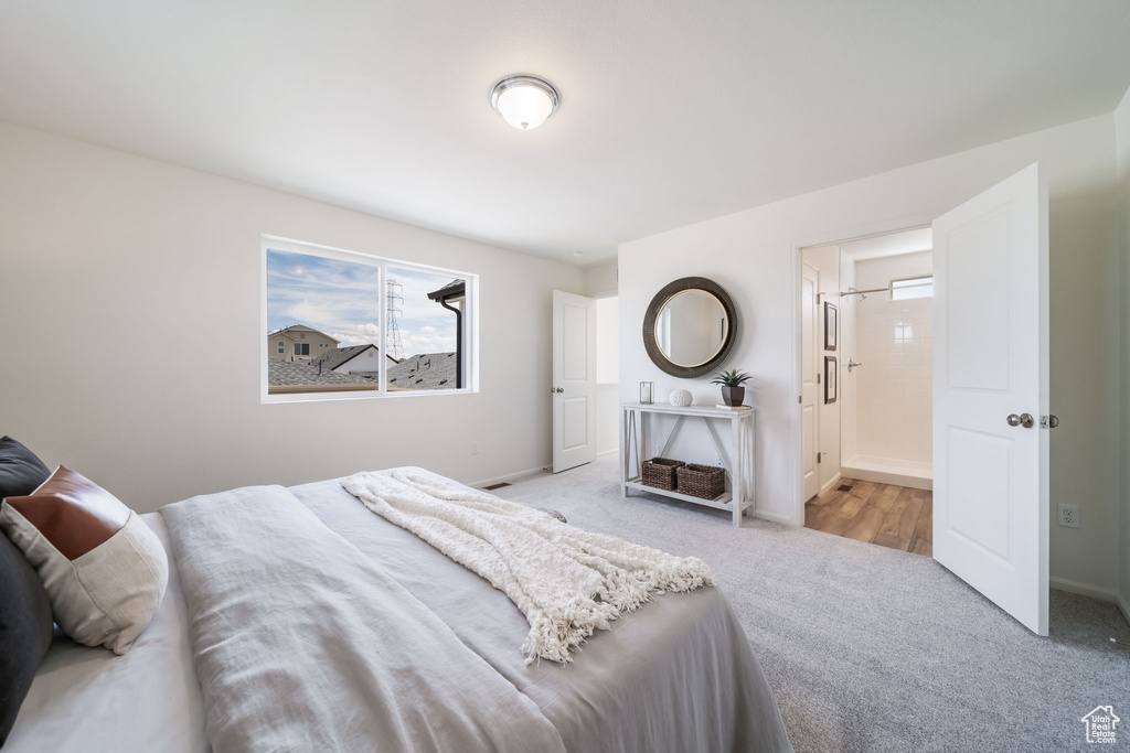 Bedroom featuring carpet and multiple windows