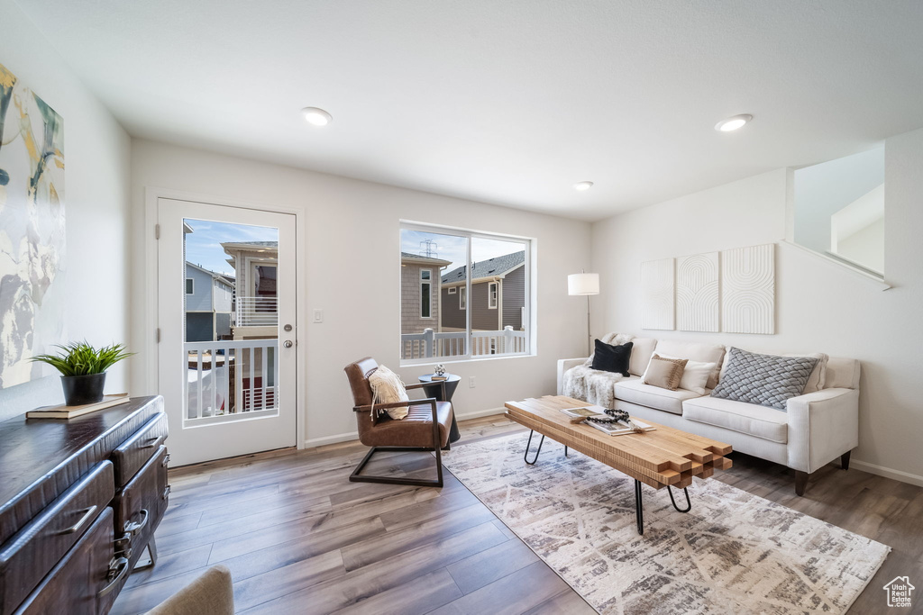 Living area with wood finished floors and recessed lighting