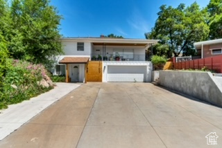 View of front of property with a garage and concrete driveway
