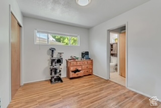 Bedroom with light wood-type flooring and a closet