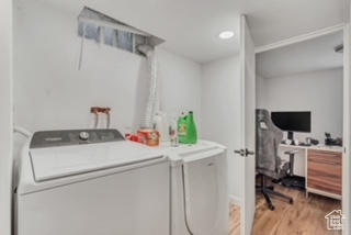 Laundry area featuring washing machine and dryer and light wood-type flooring