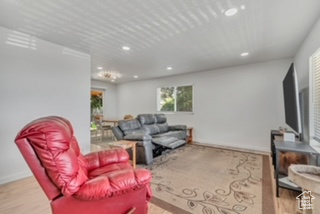 Living area with recessed lighting, baseboards, and wood finished floors