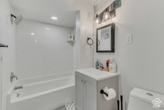 Full bath with toilet, vanity, and washtub / shower combination