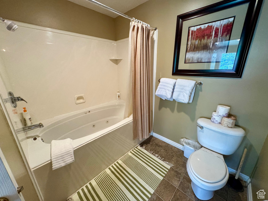 Bathroom with a combined bath / shower with jetted tub and tile patterned floors