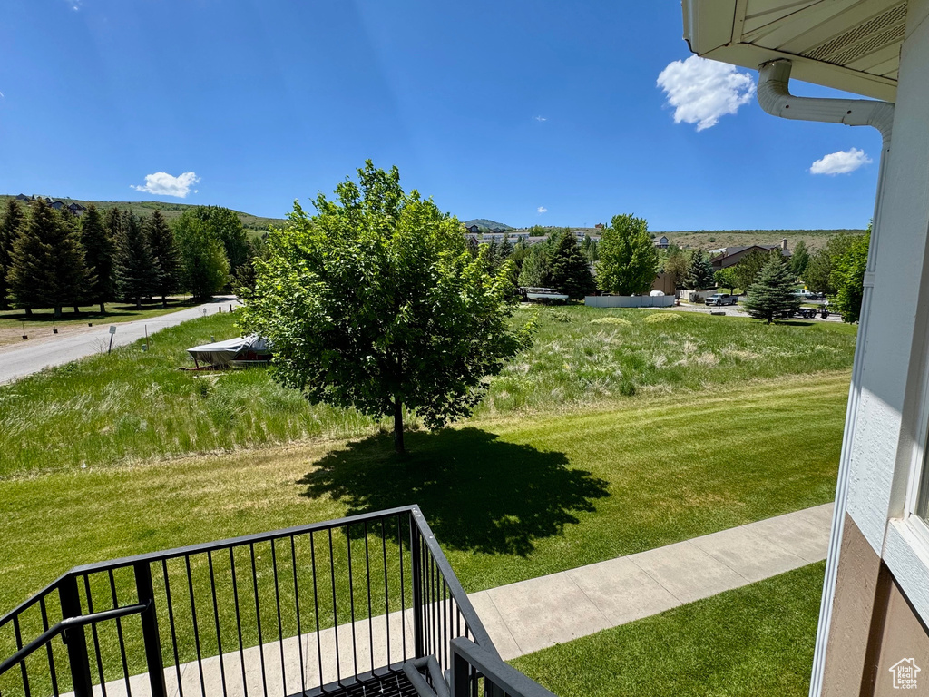 View of yard featuring a balcony