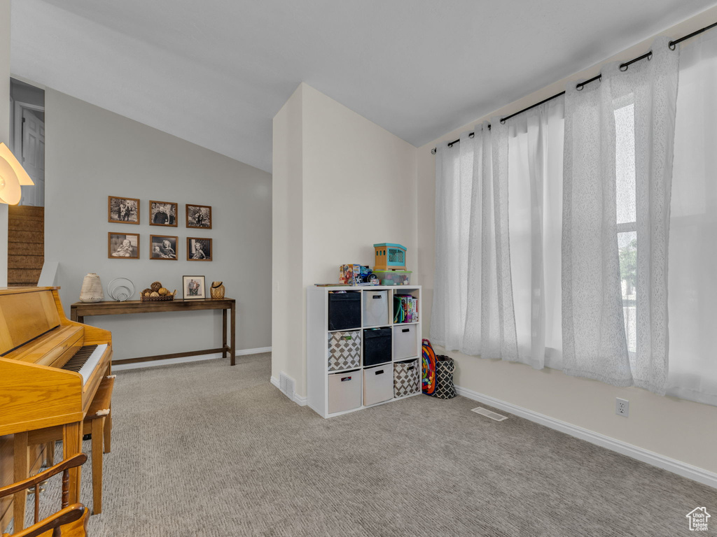 Game room featuring baseboards, carpet flooring, and vaulted ceiling