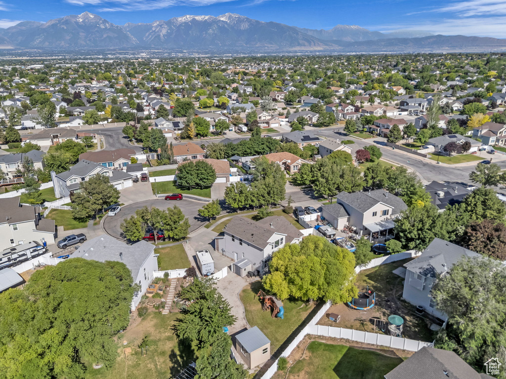 Aerial view of property's location with a mountainous background and nearby suburban area