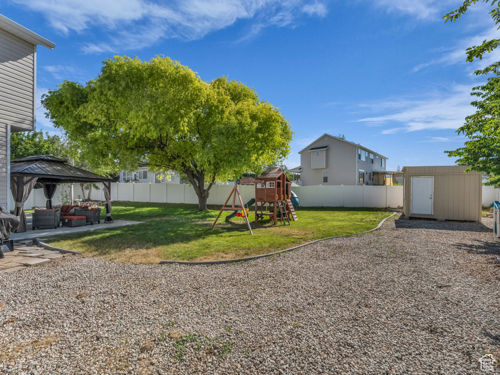 View of yard featuring a gazebo and a playground
