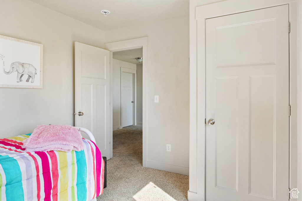 Carpeted bedroom featuring baseboards