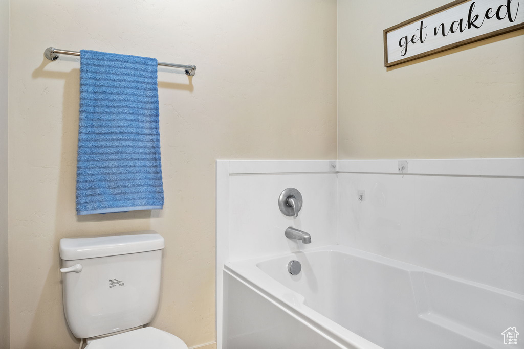 Bathroom featuring toilet and a bath
