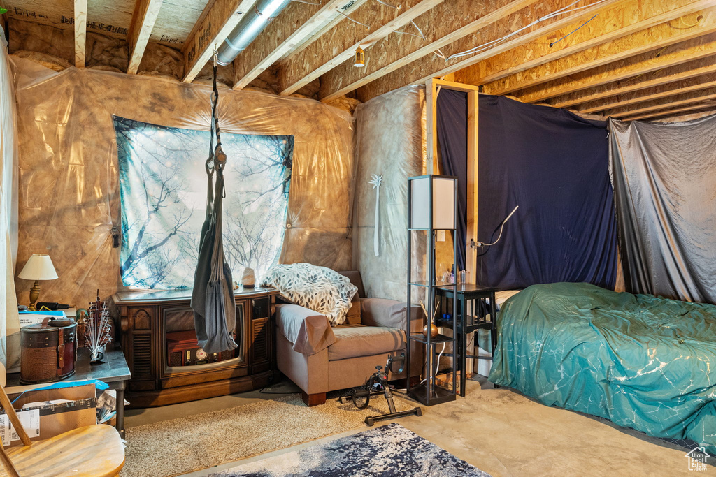 Bedroom featuring unfinished concrete floors