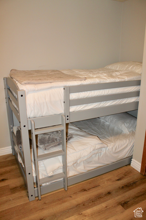 Bedroom featuring wood finished floors and baseboards