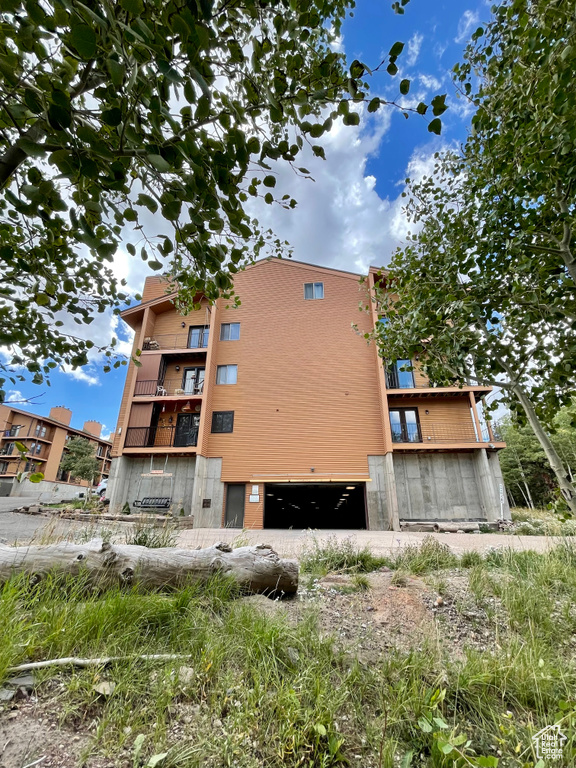 View of side of home with an attached garage