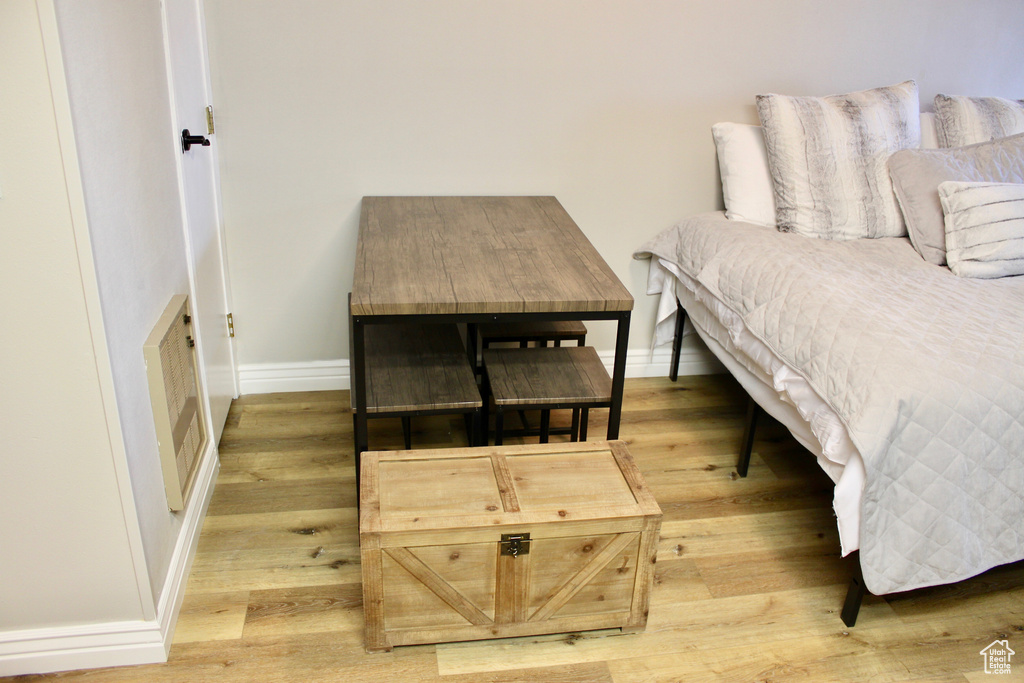 Bedroom featuring light wood-style floors and baseboards