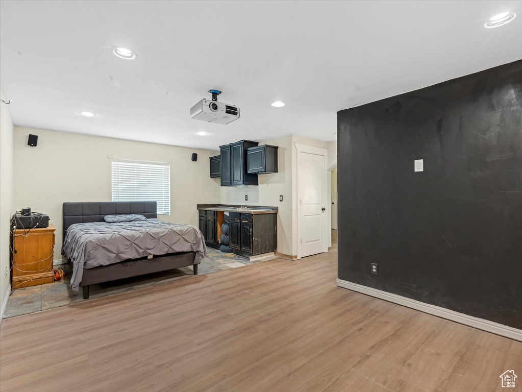 Bedroom with light wood-type flooring, recessed lighting, and baseboards