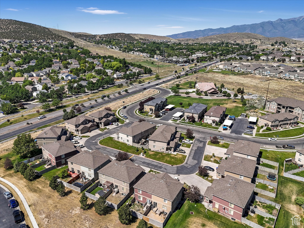 Aerial overview of property's location featuring mountains and nearby suburban area
