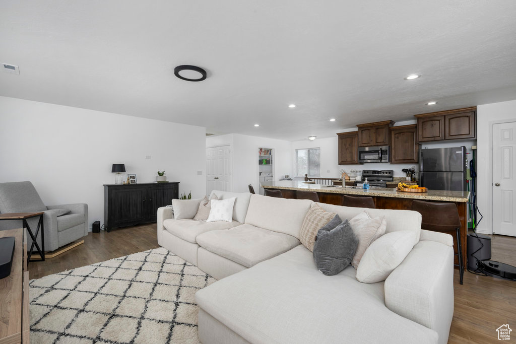 Living room with wood finished floors and recessed lighting