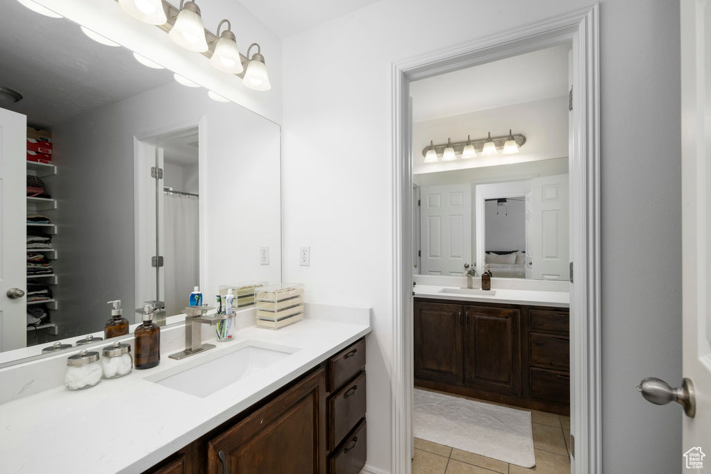 Full bathroom with tile patterned floors and vanity