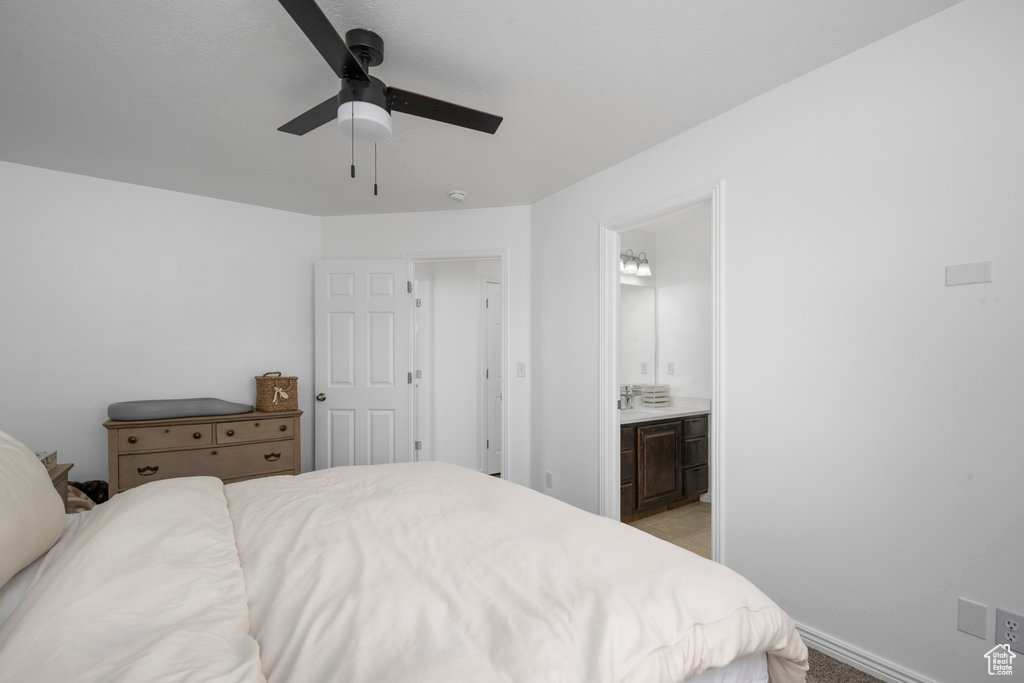 Bedroom with ensuite bathroom and a ceiling fan