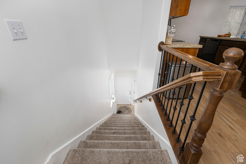 Stairs featuring baseboards and wood finished floors
