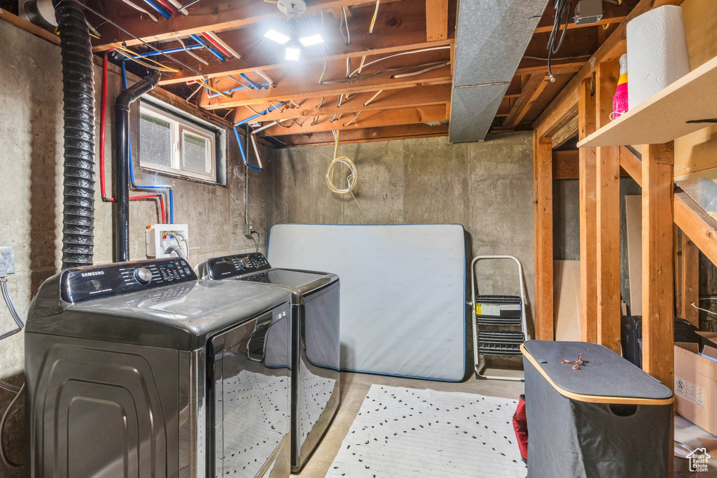 Washroom with washer and clothes dryer