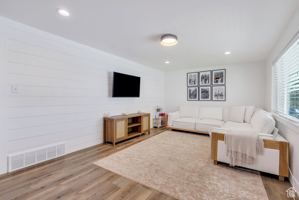 Living area featuring wood finished floors and recessed lighting