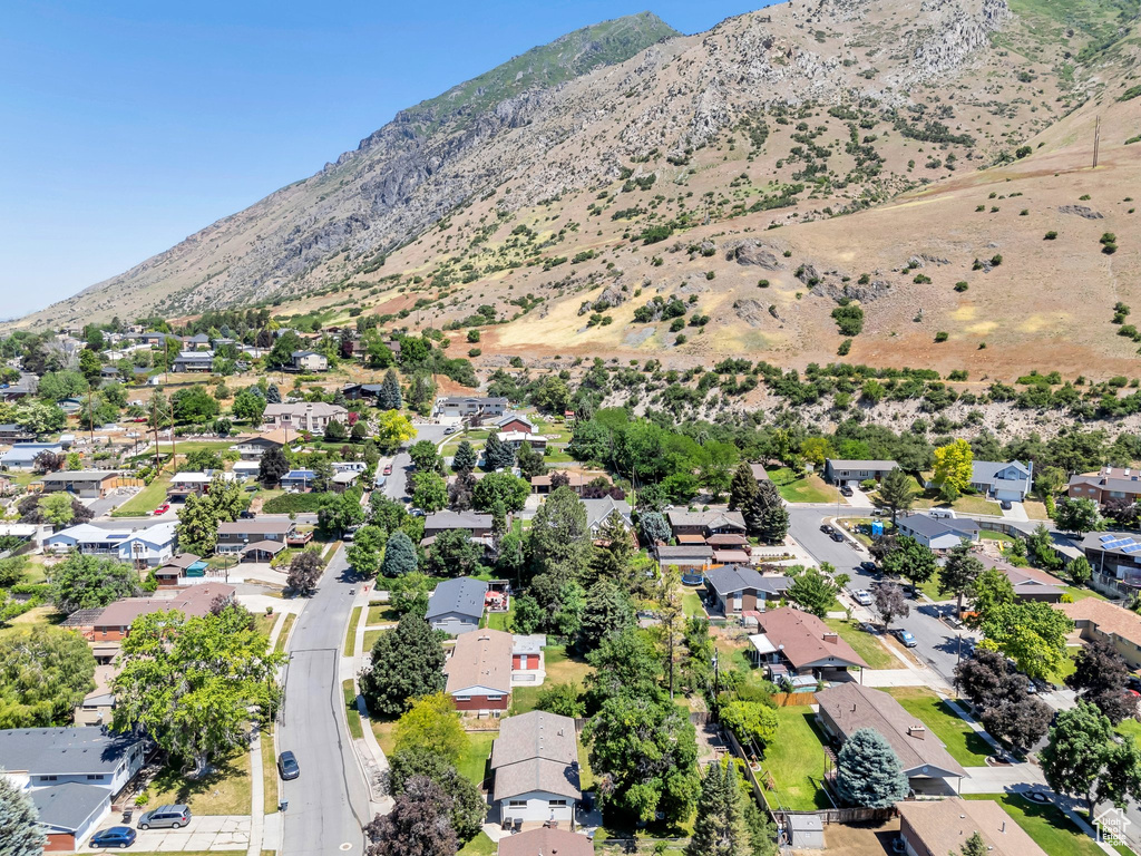 Aerial overview of property\'s location with a mountainous background and nearby suburban area