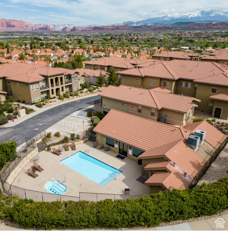 Community pool with a residential view, a mountain view, and a patio