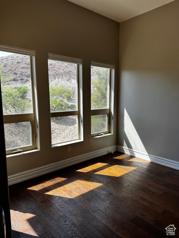 Unfurnished room with wood-type flooring and baseboards