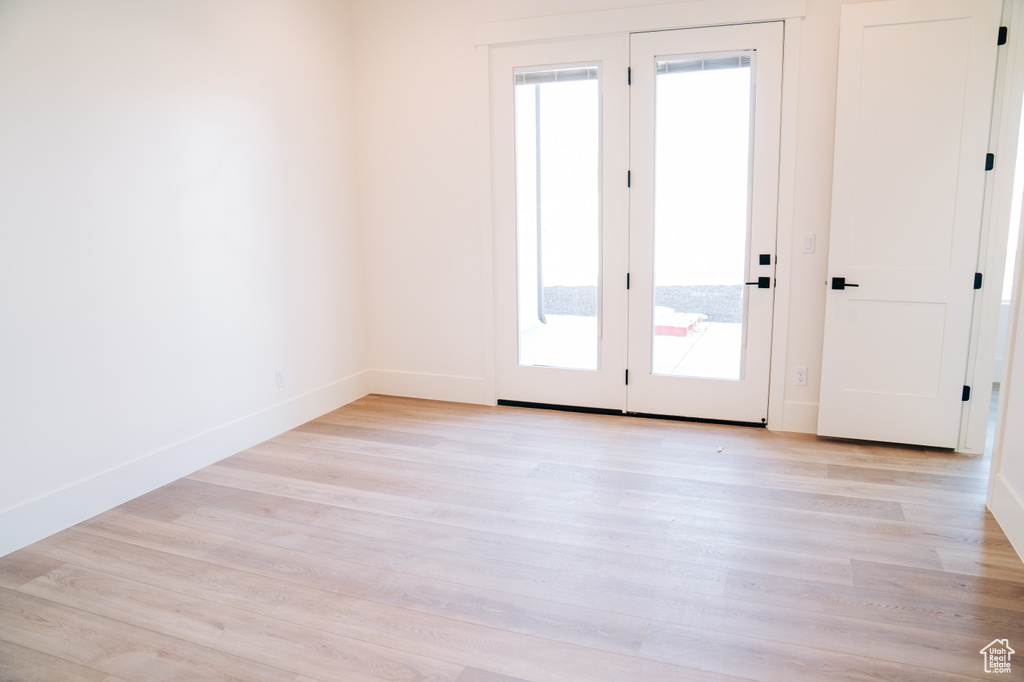 Empty room featuring light wood-style flooring and baseboards