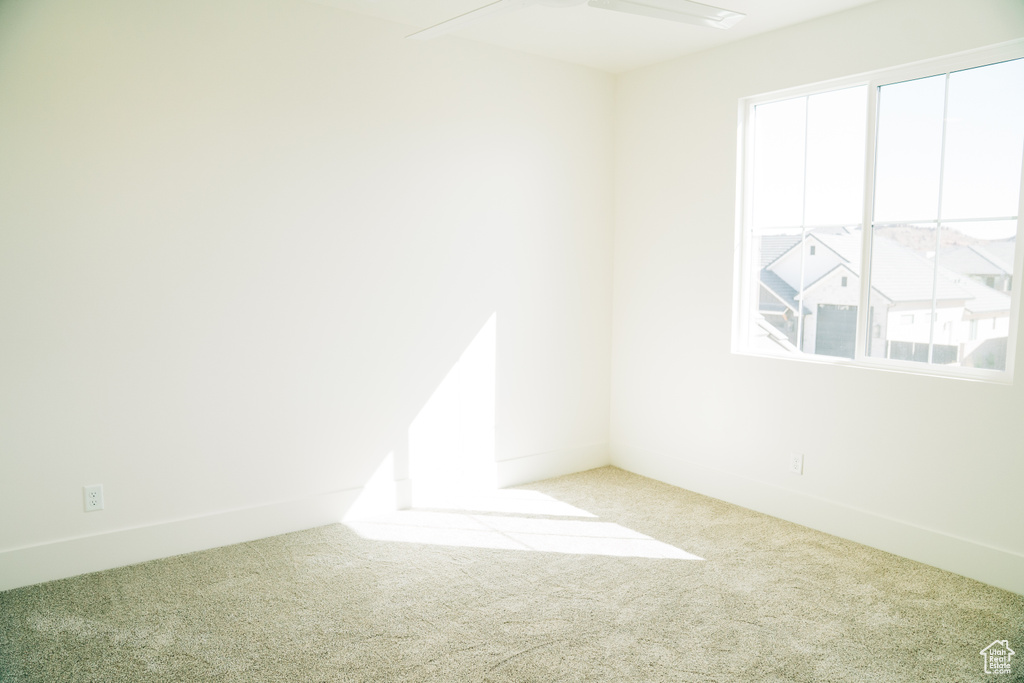 Empty room with carpet flooring and baseboards