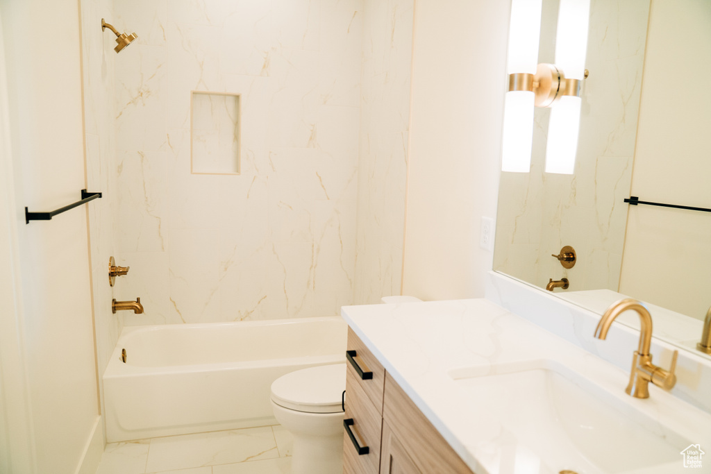 Bathroom with vanity, toilet, bathing tub / shower combination, and marble look tile flooring