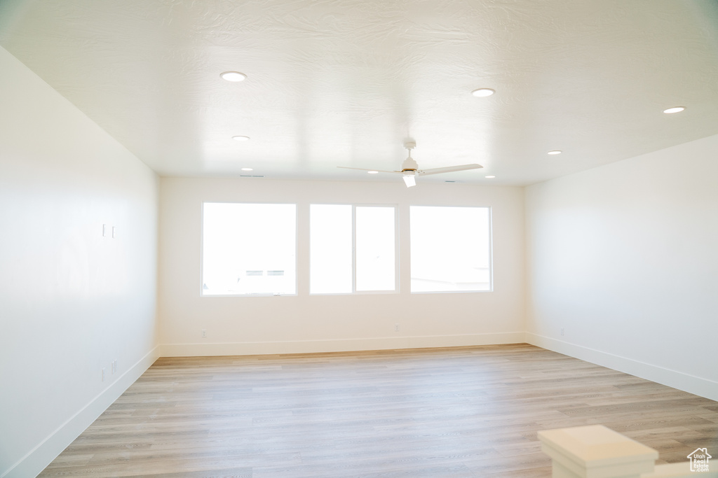 Spare room featuring ceiling fan, recessed lighting, baseboards, and light wood-type flooring