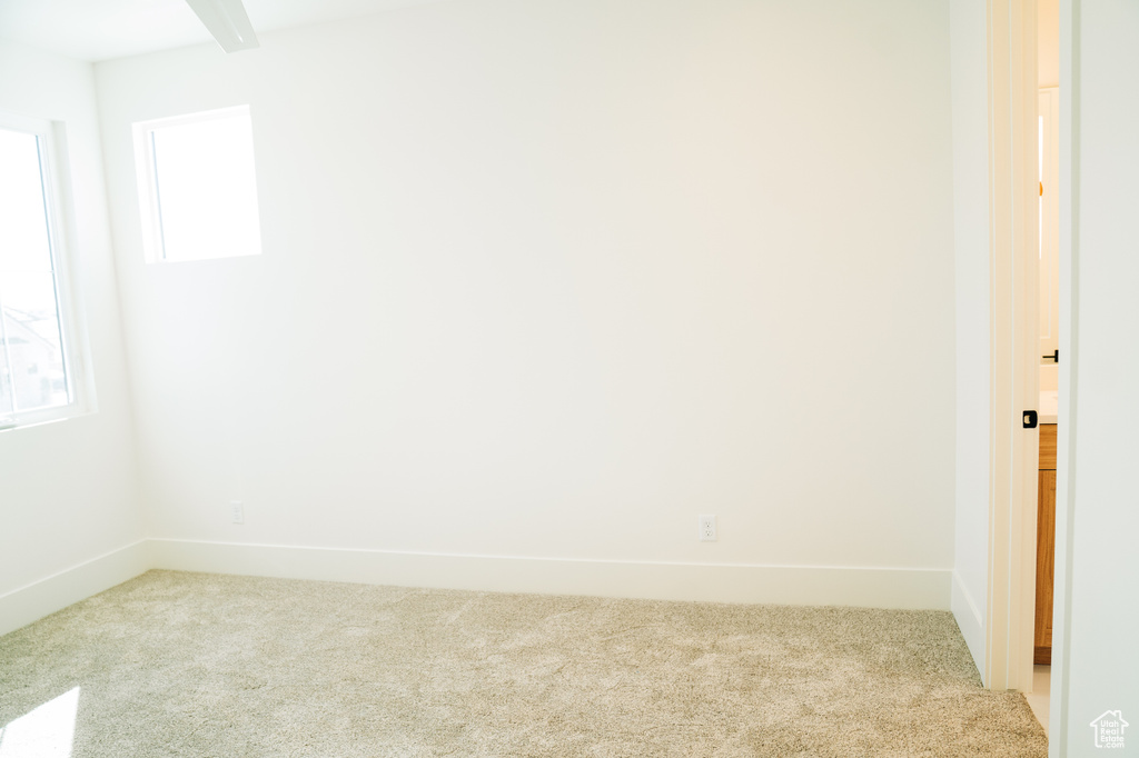 Unfurnished room with carpet and baseboards