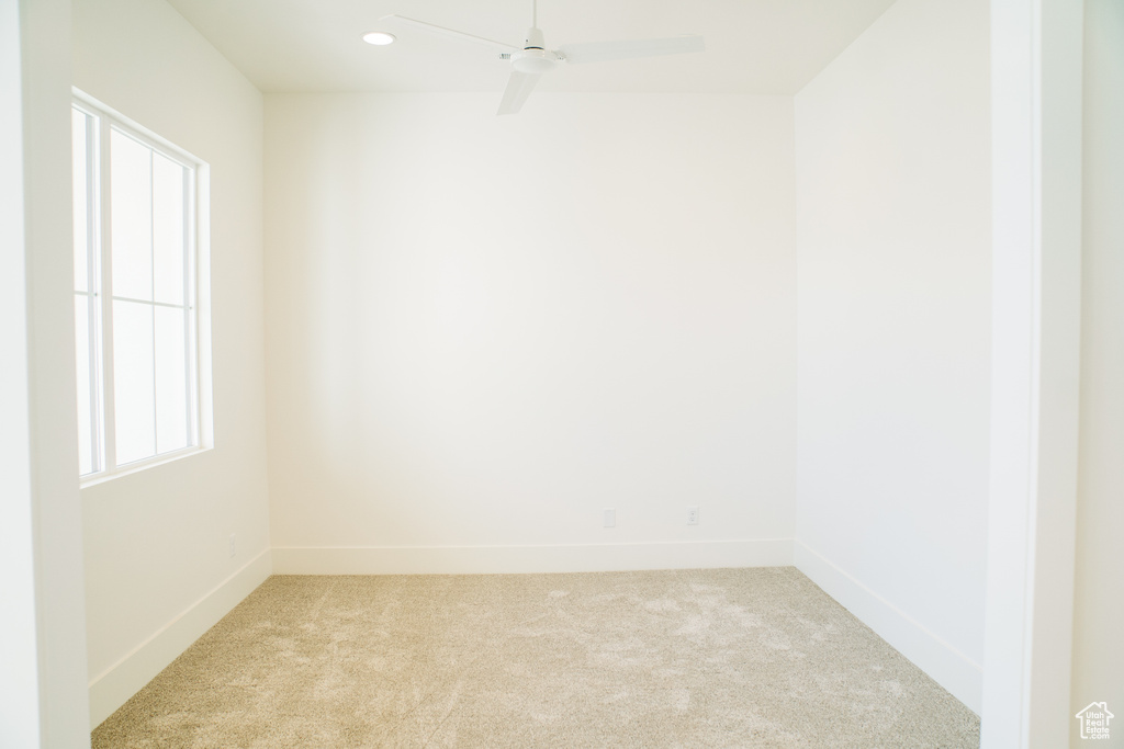 Spare room with light colored carpet, baseboards, ceiling fan, and recessed lighting