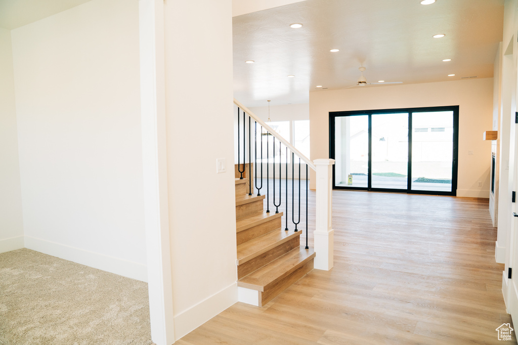 Staircase featuring recessed lighting, baseboards, and wood finished floors