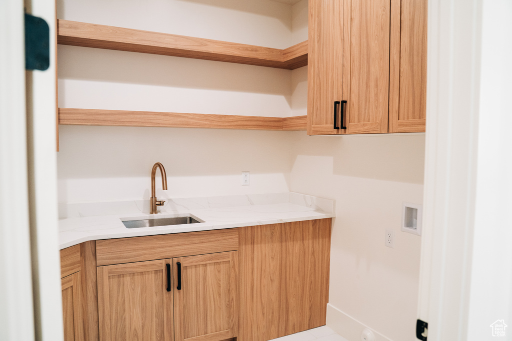 Laundry area with cabinet space and hookup for a washing machine