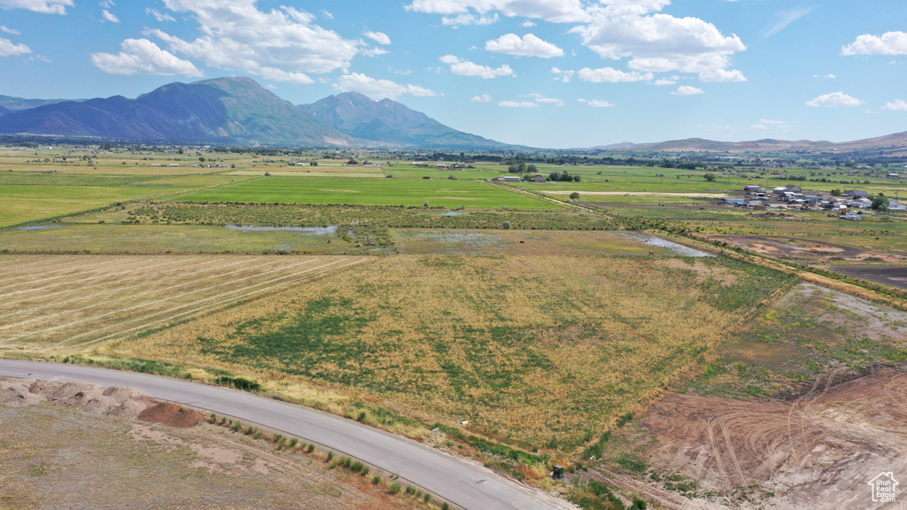 Aerial view of sparsely populated area with a mountainous background and farmland