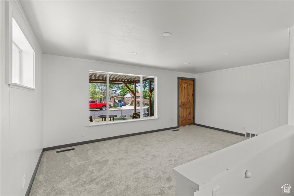 Carpeted empty room featuring baseboards