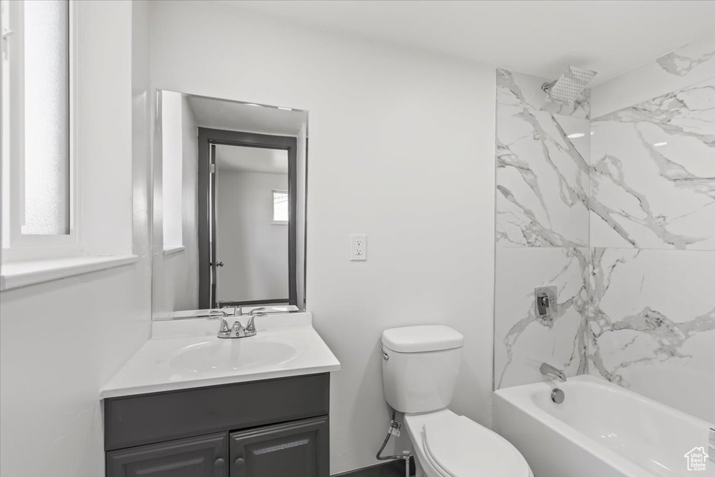 Bathroom with vanity, toilet, and bathtub / shower combination