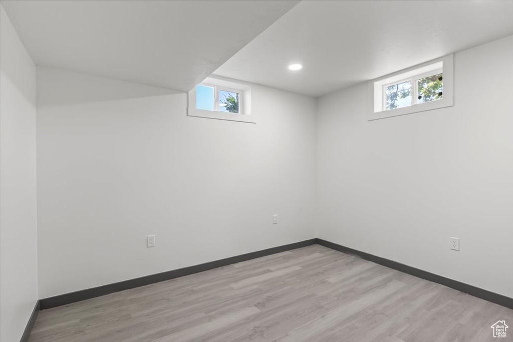 Below grade area featuring light wood-style floors, baseboards, and recessed lighting