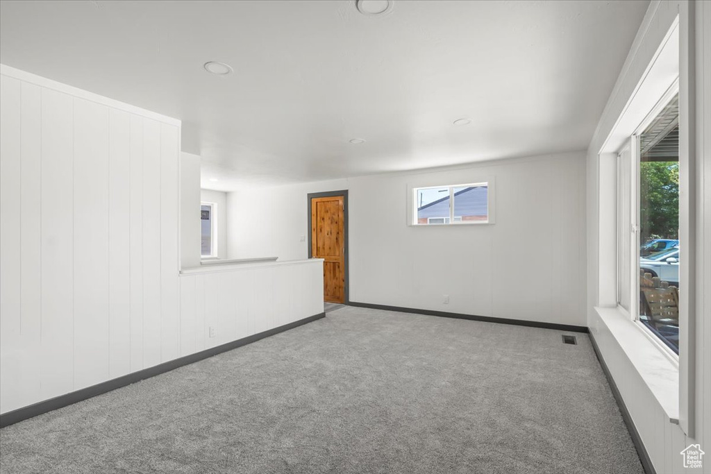 Spare room featuring carpet, baseboards, and recessed lighting