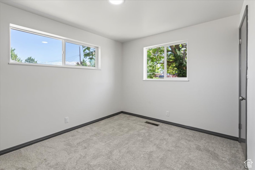 Unfurnished bedroom with carpet flooring and baseboards
