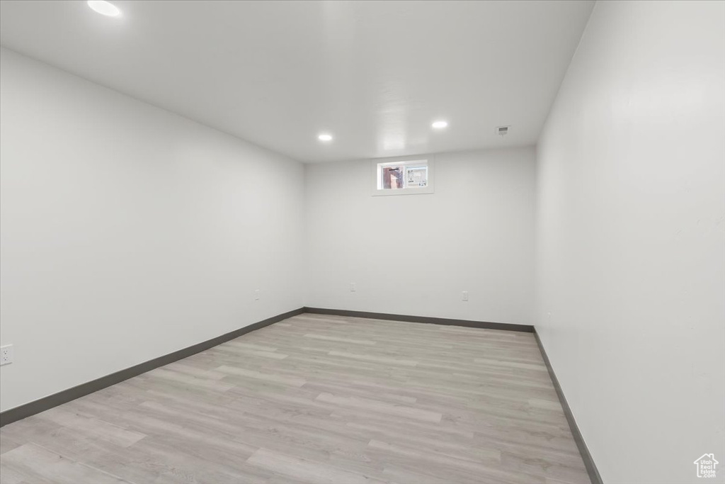 Unfurnished room featuring recessed lighting, light wood-style flooring, and baseboards