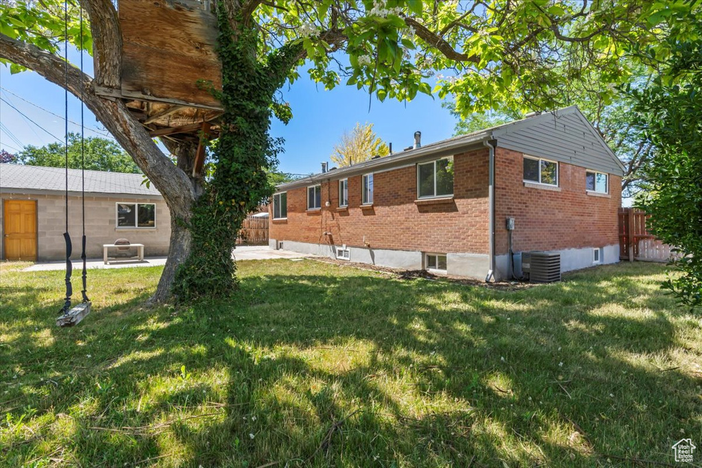 View of home's exterior featuring brick siding, a patio, and central AC unit