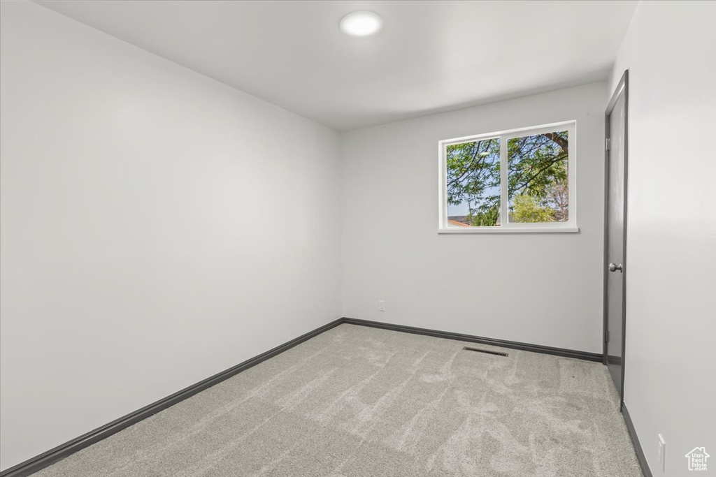 Empty room with carpet flooring and baseboards