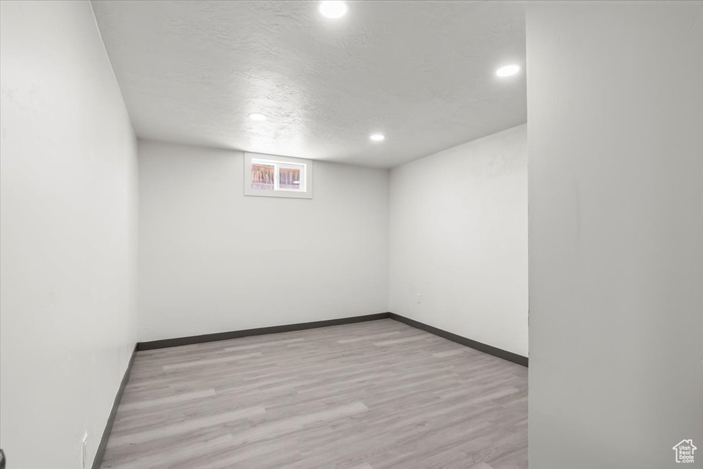 Unfurnished room featuring recessed lighting, wood finished floors, baseboards, and a textured ceiling