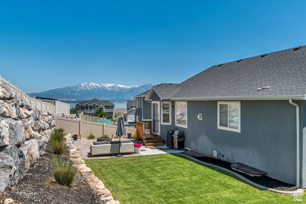 View of yard featuring a mountain view, a patio area, and an outdoor hangout area