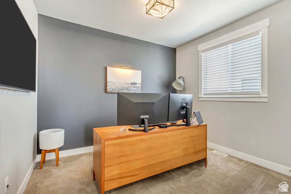 Carpeted office featuring baseboards